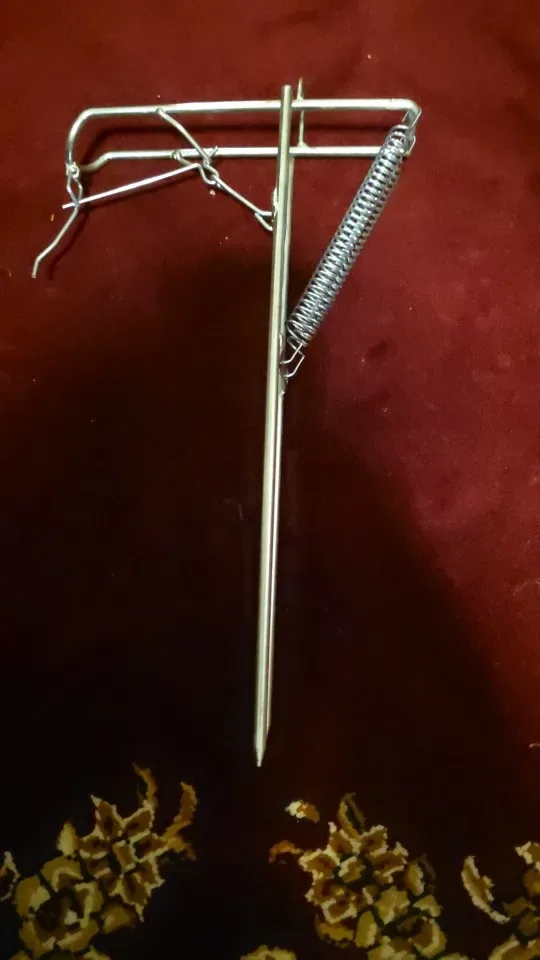 A RodPerch automatic spring rod holder staked into a soft bank